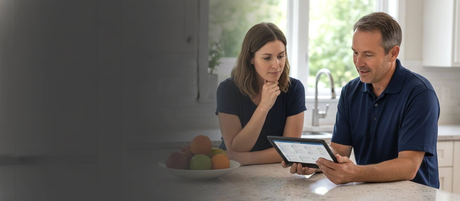 Venta technician reviewing HVAC options with a homeowner at a kitchen counter